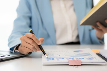 Close-up shot of Asian woman working with laptop in her office business finance concept