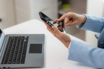 Close-up shot of Asian woman working with laptop in her office business finance concept