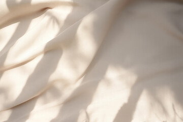 Closeup of crumpled beige silk fabric with natural light with shadow from window. High quality photo - obrazy, fototapety, plakaty