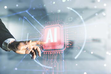 Double exposure of businessman hand working with creative artificial Intelligence abbreviation hologram on blurred office background. Future technology and AI concept - obrazy, fototapety, plakaty