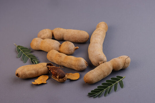 Buah Asam or Tamarind (Tamarindus) Fruit With Green Leaves.