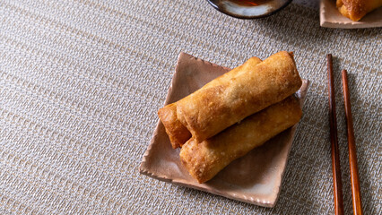 Angled view of 3 spring rolls stacked together,