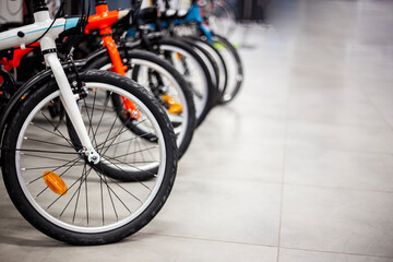 Close up of bicycles in a row in a bicycle store. Selective focus.