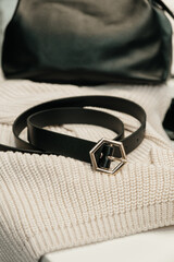 The choice of clothes, the girl's hand in choosing a dress, an outfit on a hanger in the wardrobe in the room, a closet at home. Wardrobe in the house. Clothes for women. Bags. Clothing store.