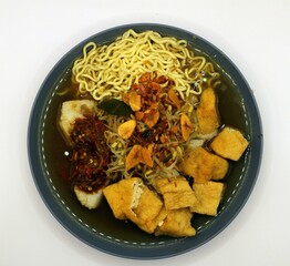 asian food, Noodles in a blue bowl with tofu on white background