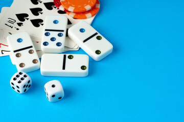 Playing cards, chips and dice on blue backgorund