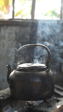 Old kettel boils  water on firewood