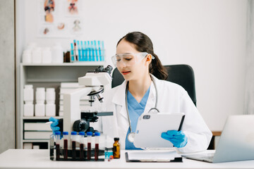 Female scientist researcher conducting an experiment working in chemical laboratory.
