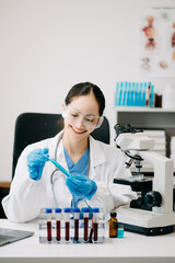 Female scientist researcher conducting an experiment working in chemical laboratory.