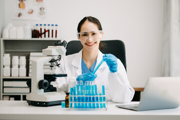 Female scientist researcher conducting an experiment working in chemical laboratory.