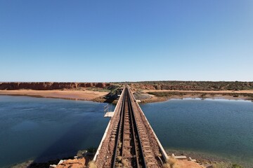 Railway bridge over the ocean in Australia. Aerial drone image.