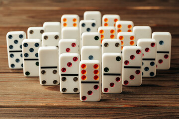 Domino tiles on wooden background close up