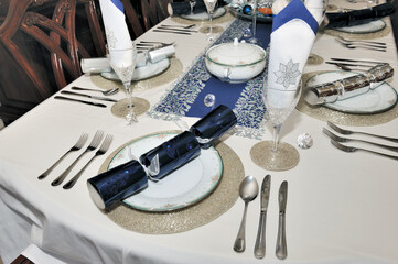 Festive navy blue and silver Christmas lunch dinner table place setting