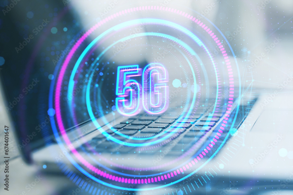 Poster close up of laptop on desk with glowing round 5g hologram on blurry background. telecommunication an