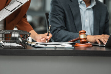 Asian male lawyer with African female client Consult with each other about lawsuits