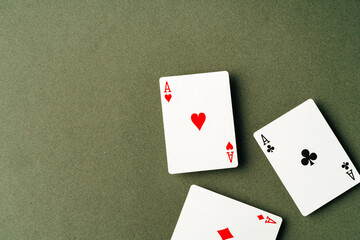 Playing cards on green background studio shot