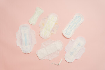 Different feminine sanitary napkins (sanitary pads) with tampon on pink background