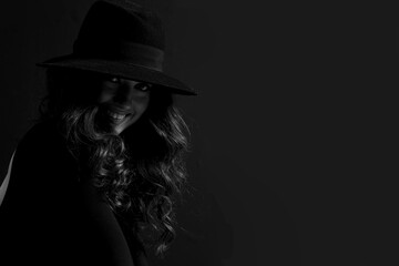 Portrait of an attractive female model in black, solated on a black background.