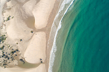 zenithal aerial drone view of the shore of a beach at dawn in northern Portugal