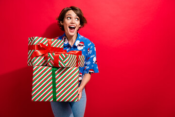 Portrait of pretty astonished girl open mouth hold pile stack giftbox look empty space isolated on red color background