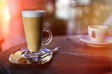 Glass cup of latte or coffe on the table in coffee shop