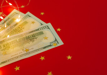 Background for holiday card with money US dollars. Background of one hundred dollar bills. Banknotes, paper currency on red background. Concept of american and global economy, exchange rate, xmas