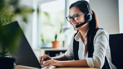 Smiling customer support operator with hands-free headset working in the office