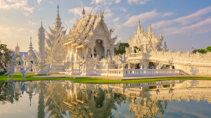 The White Temple Chiang Rai during sunset, Evening view of Wat Rong Khun or White Temple, a Landmark in Chiang Rai,  - obrazy, fototapety, plakaty