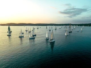 Aerial view of sailboats racing at Pula Regatta along the harbour at sunset, Pula, Istria, Croatia.