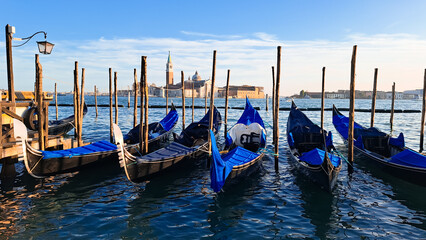 Beautiful seascape with gondolas on the blue sea water in Venice - obrazy, fototapety, plakaty