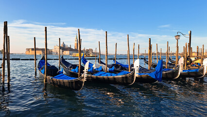 Fototapeta premium Beautiful seascape with gondolas on the blue sea water in Venice