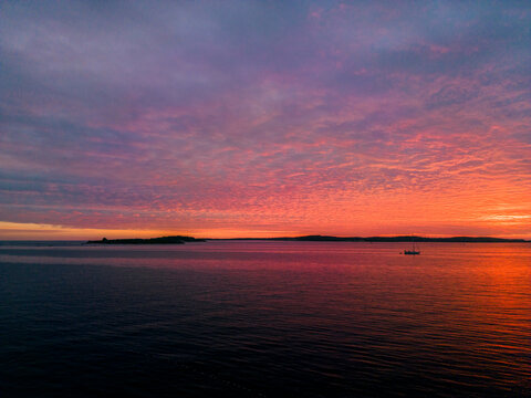 Aerial view of a dramatic sunset along the Adriatic sea coastline near Pula, Istria, Croatia.