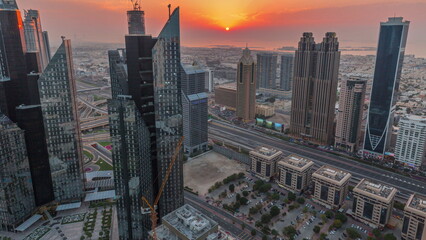 Fototapeta na wymiar High-rise buildings on Sheikh Zayed Road in Dubai aerial timelapse during sunset, UAE.