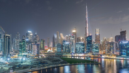 Aerial view to Dubai Business Bay and Downtown with the various skyscrapers and towers night timelapse