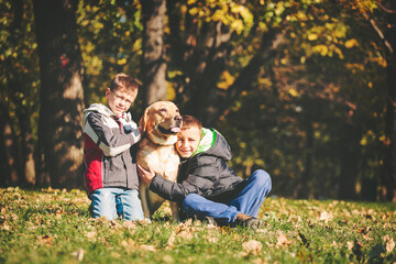 Fototapeta premium Boys with their dog outdoors in nature