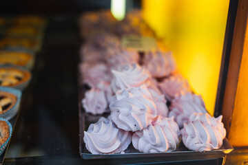 Lots of fresh pastries and desserts on the bakery and store counter - craft sweets