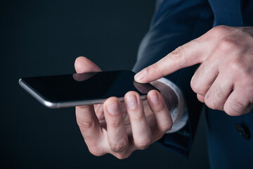 Close up shot of businessman using smart phone