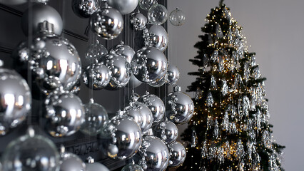 Silver Christmas decorations. Beautiful silver background with shiny silver balls. Festive mood. Christmas or holiday theme