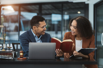 Teamwork of business lawyer meeting working hard about legal legislation in courtroom to help their...