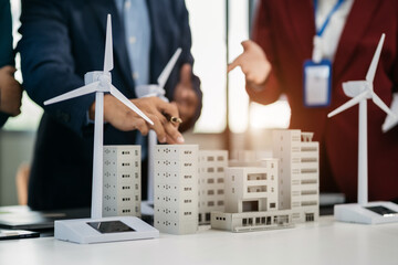 Business team brainstorming using tablet, laptop computer for working technology and business,  Renewable energy-based green businesses and global warming.