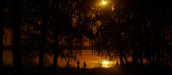 4 four People cycling together, couple of pedestrian walking near sunset sea. silhouette of woman,...