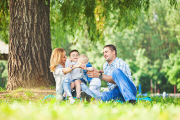 Fototapeta premium Happy family with two children by the river