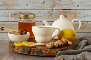 Fall immune system booster - ginger and lemon tea and ingredients on rustic wood background