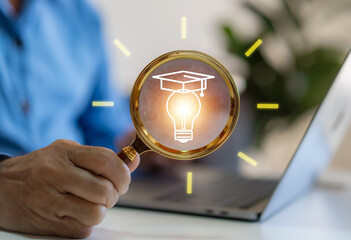 Human holding magnifier with light bulb and graduation hat learning, study, education, knowledge,...