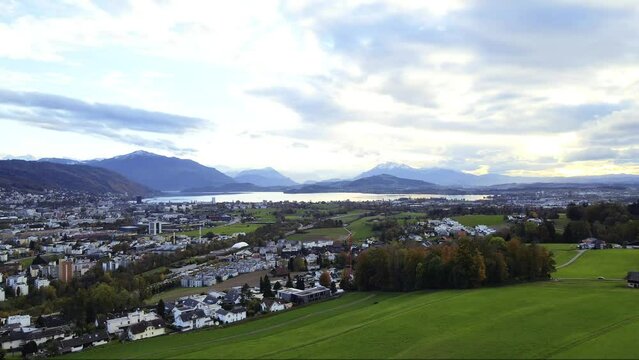 vertical panoramic view of the Swiss city of Zug on the picturesque shores of Zugersee Lake featuring Mount Pilatus and Mount Rigi in Switzerland