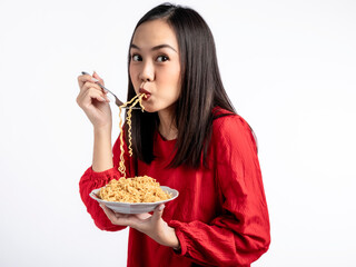 A portrait of a happy Asian woman wearing a red shirt, eating noodles. Isolated against a white background.