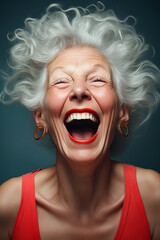 Woman with white hair and earrings laughing with her eyes closed.