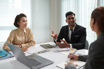 Group of business people discussing ideas for project development in meeting