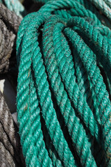 Close up of bright green fishing rope on quayside in fishing village in Devon, UK.