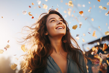 Happy brunette woman excited looking up in the confetti